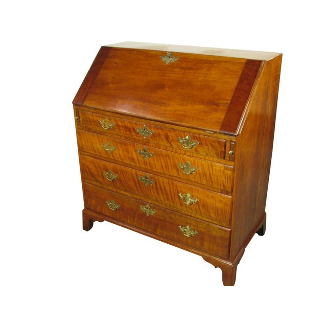 An 18th-C. American slant lid desk featuring outstanding figured solid black cherry wood throughout. The slant lid opens...
