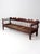 An antique 19th-century wooden bench featuring an elaborately scalloped crest rail, slender turned spindles, shaped arms,...