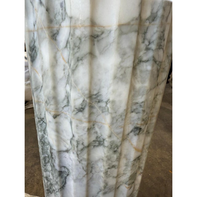 Timeless and architectural, this impressive pair of fluted marble columns is carved from richly veined Verde Alpi marble,...