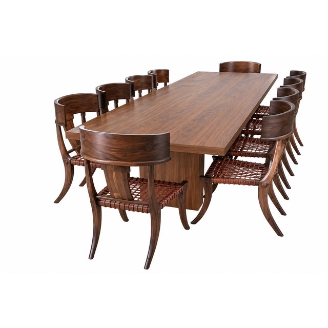 Klismos solid walnut dining chairs. The chairs are made of solid walnut with a satin finish and leather cording. The...