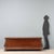 Walnut chest. Front with serrated frame under the top, projecting uprights carved with rosettes and leaves, and feral...