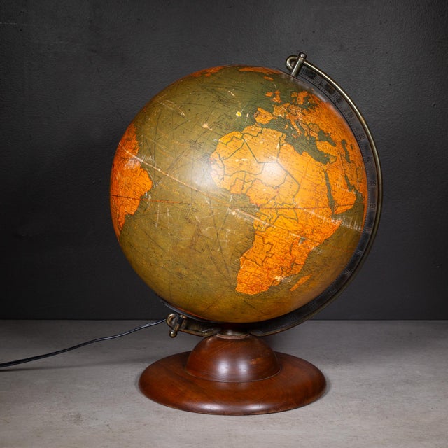 ABOUT An original 12" library globe manufactured by Replogle and edited by cartographer, Gustav Brueckmann. It is composed...