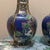 This matching pair of Chinese Famille Rose porcelain vases features a distinctive hexagonal form and a vibrant cobalt blue...