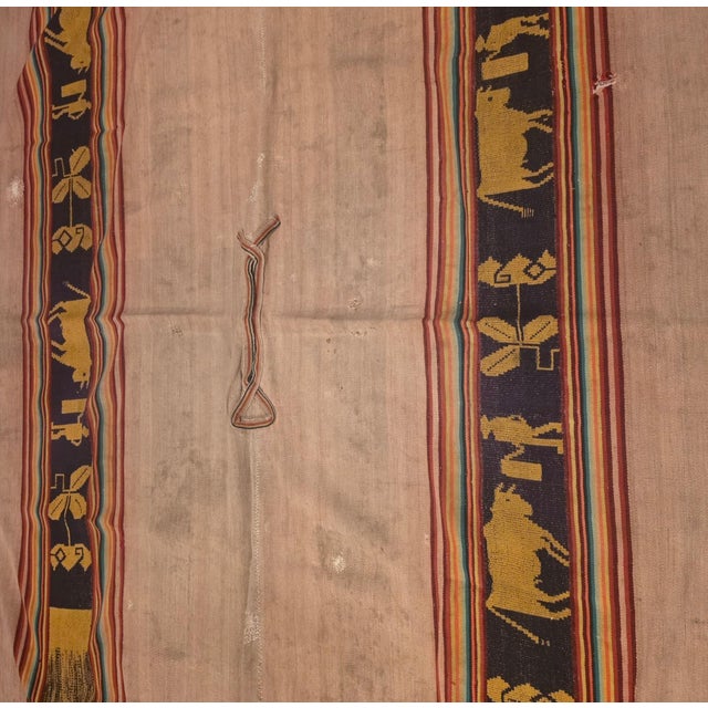 A remarkable early 20th-century Andean handwoven poncho, presented today as a striking piece of collectible textile art....