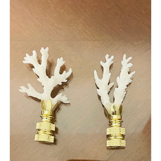 Organic modern sea ocean branch fragments placed on brass bases as lamp finials.