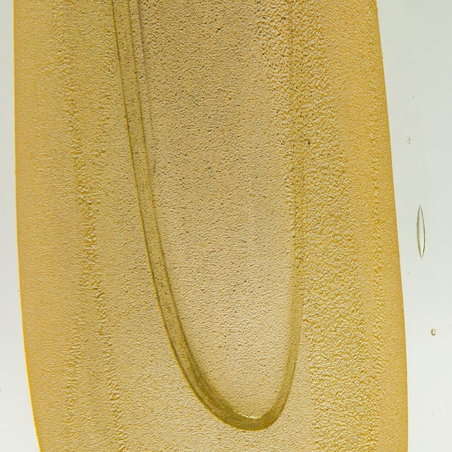 The Hand-Blown Murano Fluid Vase is a striking testament to the unparalleled craftsmanship of Murano’s master glassmakers....