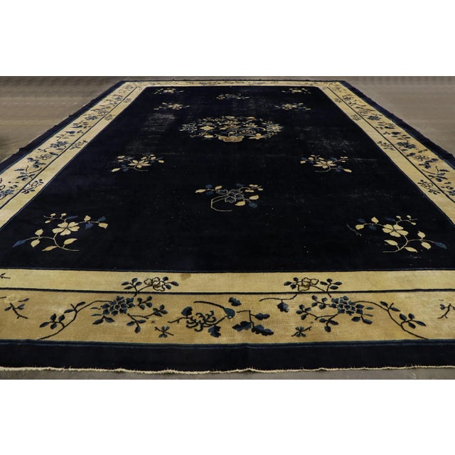 78131 Distressed Antique Chinese Peking Rug with Rustic Chinoiserie Style 12'02 x 18'02. This hand-knotted wool antique...