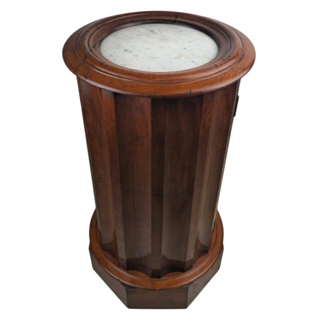 An original Biedermeier drum cabinet of cylindrical form, crafted in Germany around 1820. The body is of nutwood with fine...