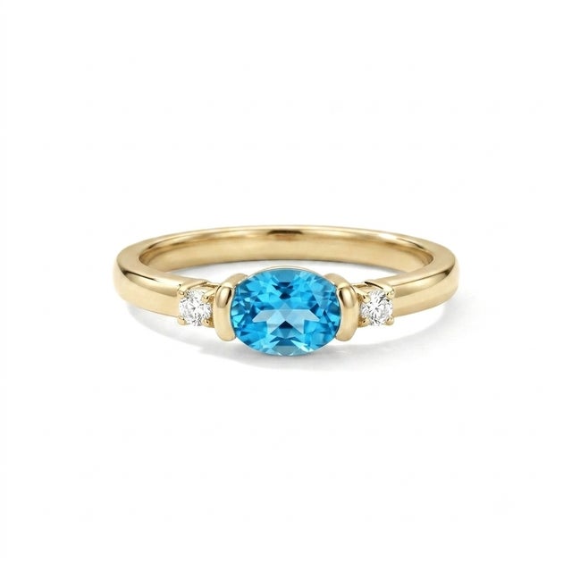Sophisticated, contemporary, and beautifully minimalist. This exquisite three-stone ring features a stunning 6x4mm oval-...