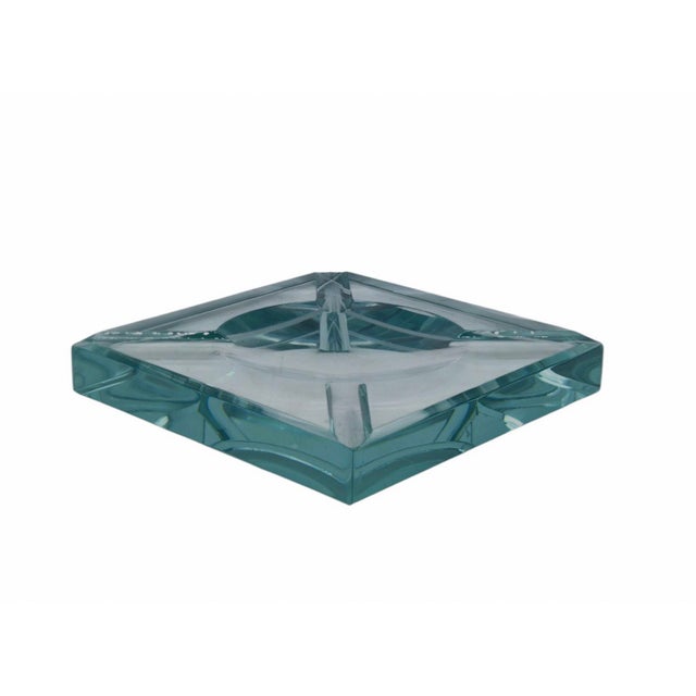 A stunning ashtray in cut and bevelled Nile green glass. The geometric design, cut from a block of glass 2 cm thick and 12...
