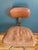 This vintage Cramer chair has a leather back and cloth seat. The base is made of sturdy metal with rolling wheels. It is...