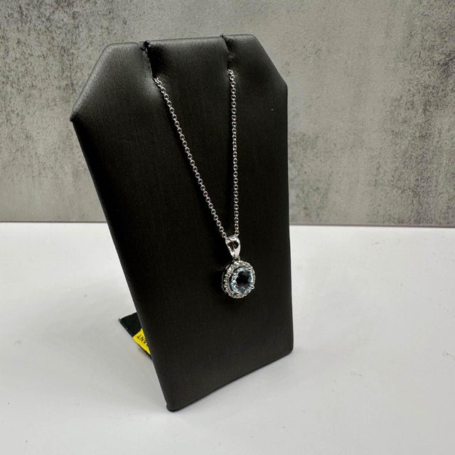 This stunning Aquamarine and Diamond Necklace in 14kt white gold features a 6.9mm round aquamarine, complemented by...