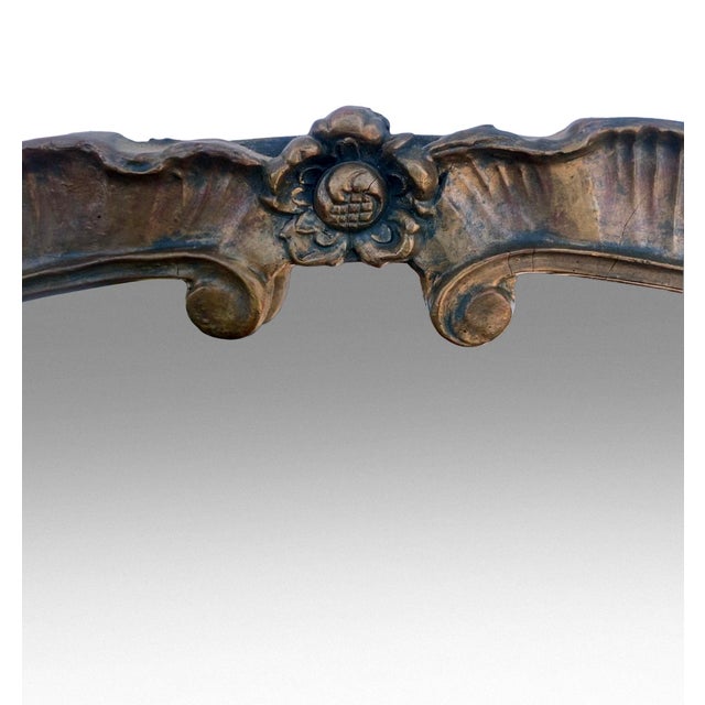 Oversized early 20th‑century round carved wood mirror featuring a wide, sculpted frame with layered relief detail. The...