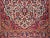 An early 20th century hand-knotted Persian Kashan rug, distinguished by its rare and coveted ivory field color and...