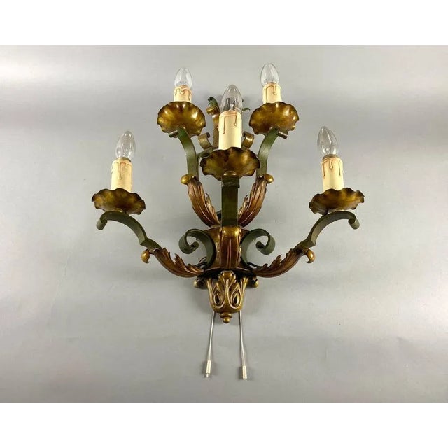 Wonderful an old five-light metal wall sconce with gold acanthus leaves and scrolles in a beautiful original shape. The...