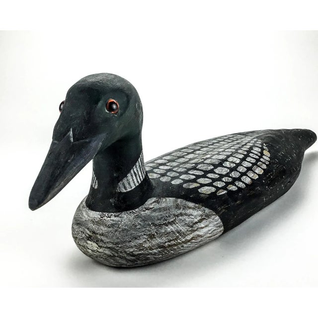 Duck Statue carved from wood and hand painted. Signed at the bottom by the artist. In wonderful vintage condition and...