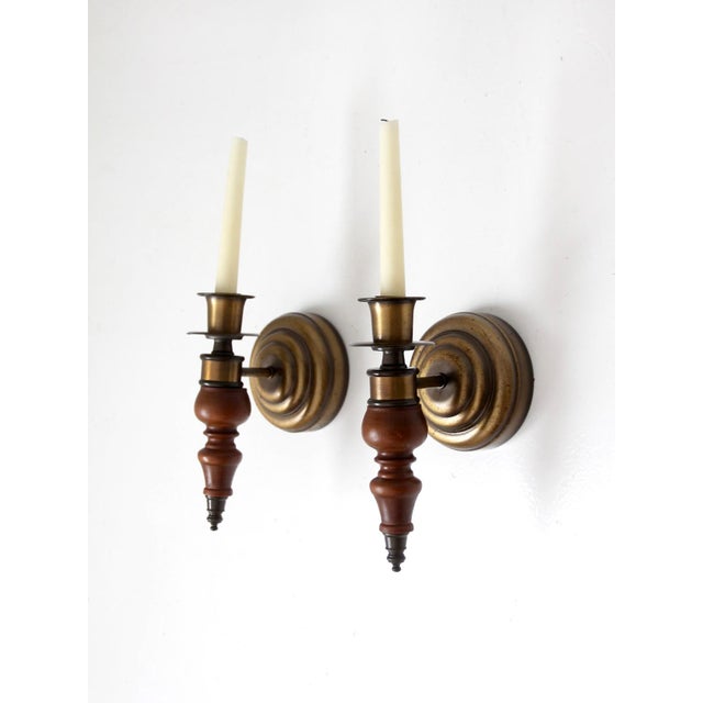 This pair of vintage Colonial Revival candle sconces has a handsome traditional profile with warm turned wood and softly...