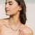 This graceful tennis necklace is crafted in 925 sterling silver and adorned with 63 natural opal gemstones, each carefully...