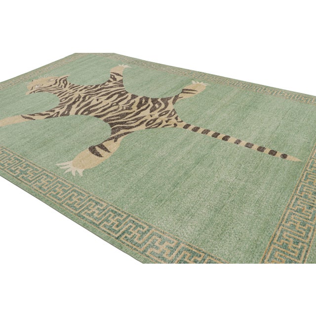 Hand-knotted in wool, this 10x14 tiger pictorial rug has been particularly inspired by a mid-century Indian depiction of...