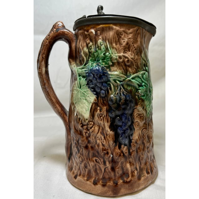 Metal Antique 19th Century Majolica Pitcher /Jug With Pewter Top Decorated With a Vibrant Grape & Vine Pattern Against a Brown Tree-Like Textured Background For Sale - Image 7 of 11
