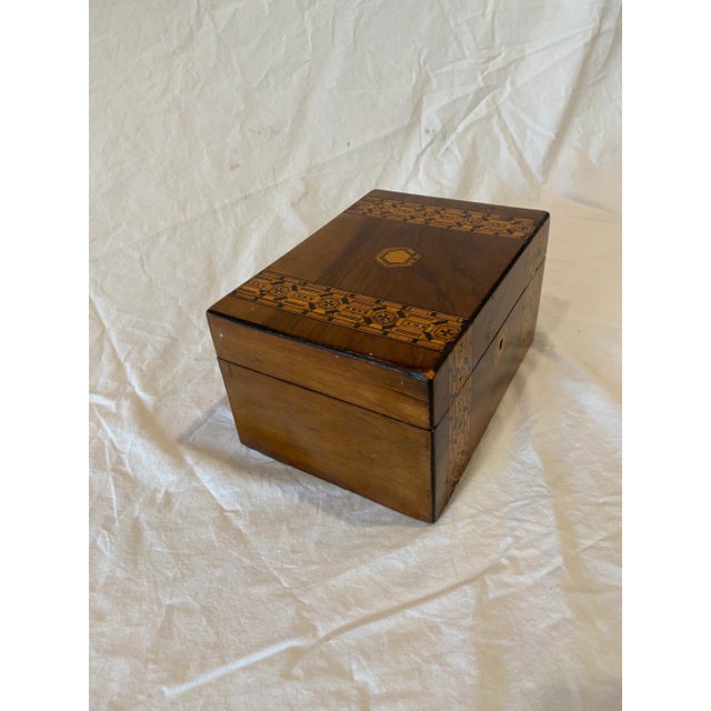 Antique wood tea caddy with intricate parquetry inlaid banding. Note that the inside has been modified.