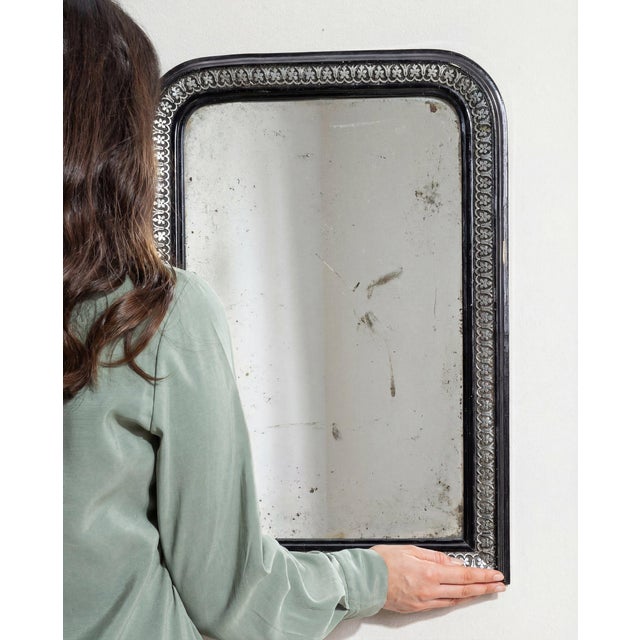 This mirror carries genuine presence, its black ornate beaded frame, arched top immediately setting the tone for the...