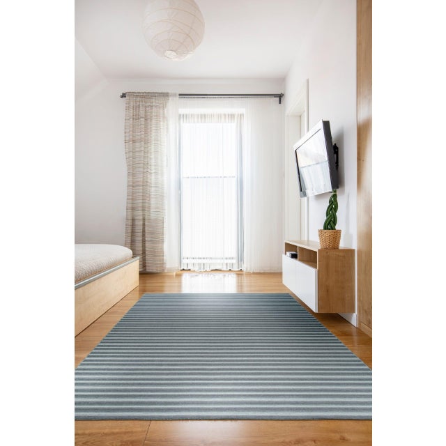 Lush Timeless Gray Flatweave Wool Rug, Country of Origin: India. This contemporary flatweave piece utilizes the ancient...