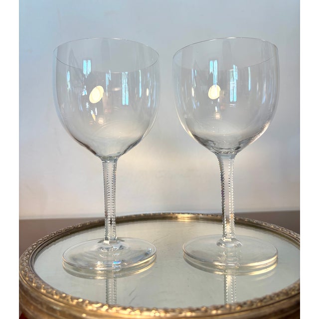 An exquisite pair of crystal glasses in the elegant balloon-shaped model by baccarat, crafted in france prior to 1936. As...