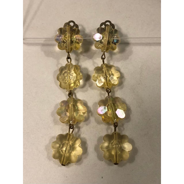 Imagine your hair swept back in an up-do so these stunning 3” long Austrian Yellow Floral Lucite Dangle Earrings can take...