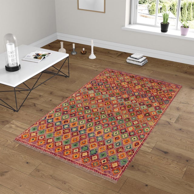 This stunning hand-knotted Afghan Balouchi rug is a captivating addition to any decor. Crafted by skilled artisans, it...