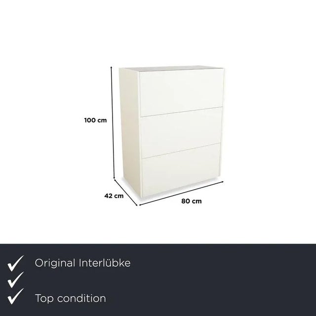 The Interlübke Cube Sideboard is a compact storage unit with a clear, minimalist design. The body is finished in matte...