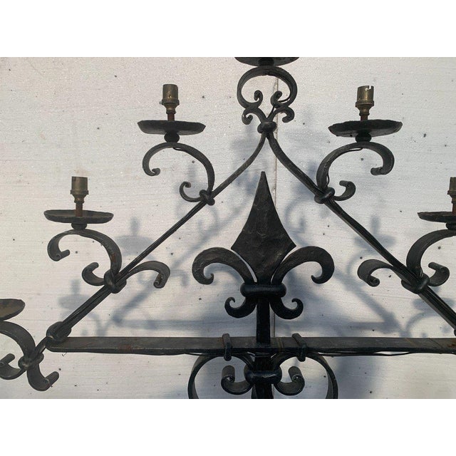 Hammered iron candlestick with seven light points Twisted central shaft with tripod base Good condition Dimensions: H 183...