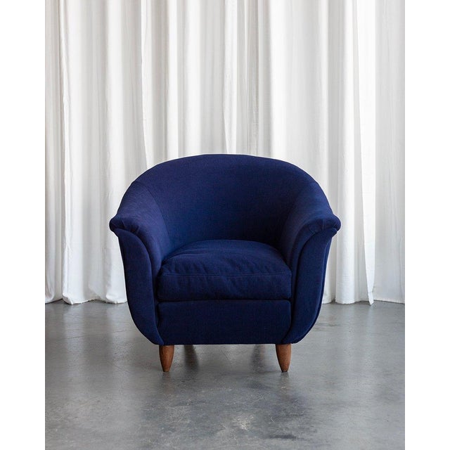 The armchairs were reupholstered in dark blue high-quality fabric. They come from the 1940s and their blossoming tulip...