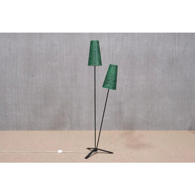 This striking floor lamp was designed in Sweden in the 1950s. The design features a three-legged base in black lacquered...