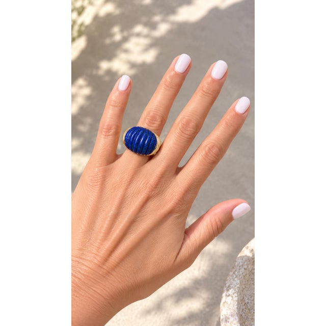A striking vintage Italian 18K gold ring featuring a beautifully carved lapis lazuli dome in a bold bombe silhouette. The...