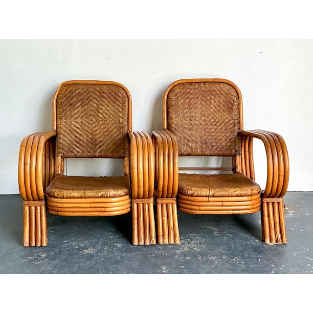 This elegant pair of vintage bent rattan lounge chairs beautifully embodies the organic design sensibilities of the...