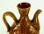 A handcrafted studio glazed terracotta piece Red ware pottery water jug or wine pitcher with handle Majolica glaze in...