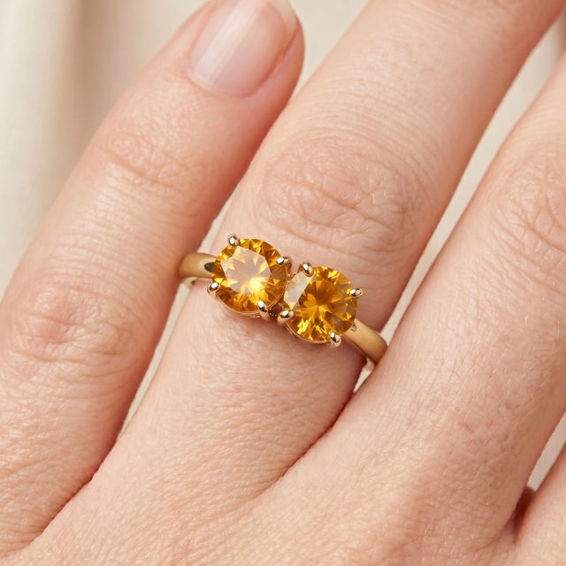 Radiate warmth and positivity with this gorgeous 18k gold-plated two-stone ring. Featuring a pair of brilliant-cut, honey-...