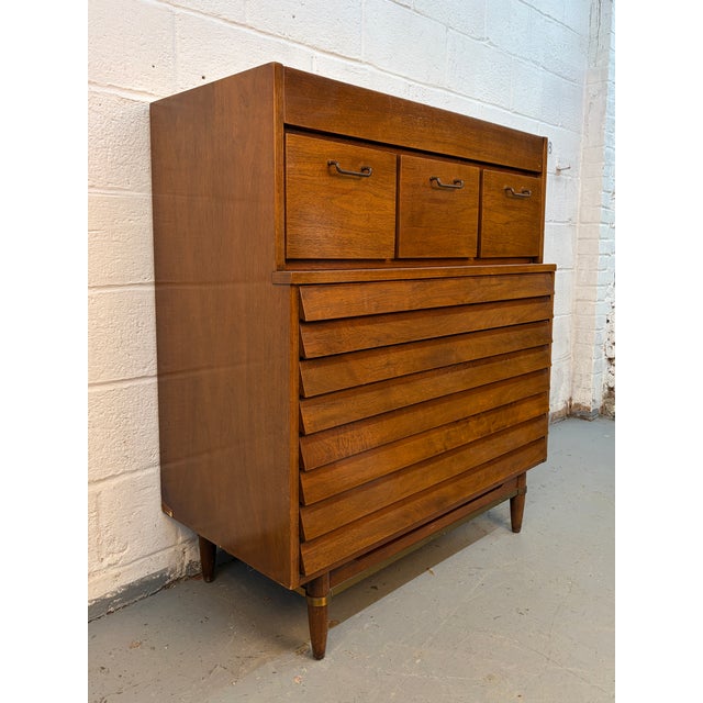 Iconic “Dania” highboy dresser designed by Merton Gershun for American of Martinsville. A standout example of Mid-Century...