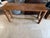 Striking "Edie" Natural Rattan and Brass Console Table designed by Spain’s Mermelada Estudio for CB2. This highly sought-...