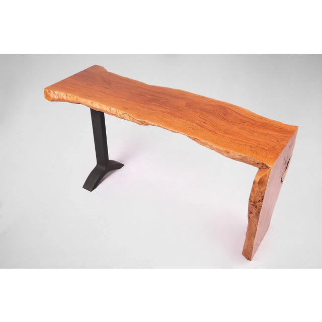 Almost straight cut top and living edge legs, this contemporary console table displays a clean, graceful, modernist...