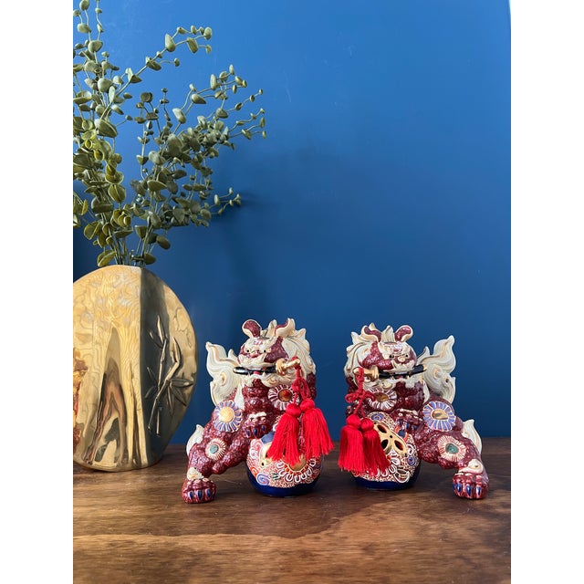 Beautiful pair of vintage Chinese guardian lions (Foo Dogs / Shishi), richly decorated with textured red enamel,...