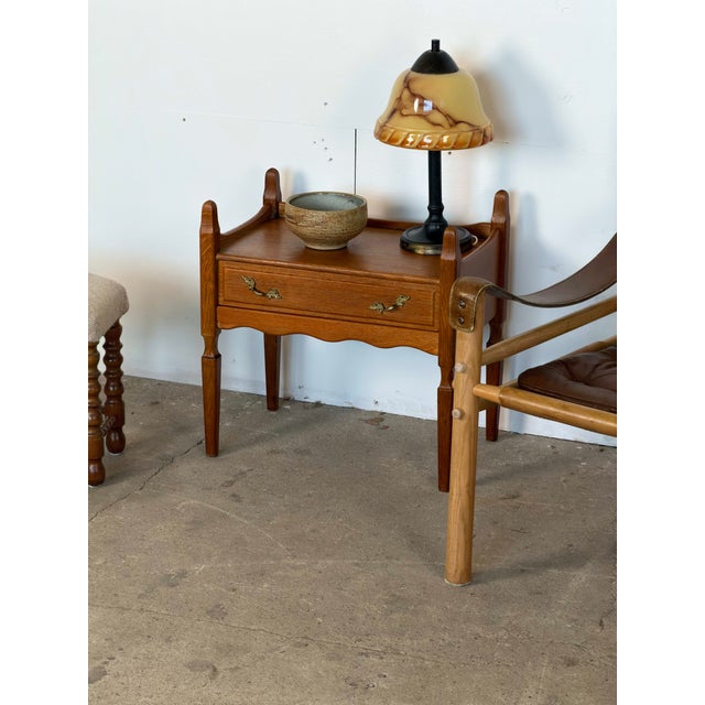 Danish pair of nightstands in solid oak, attributed to Henning Kjærnulf, 1960s. Each stand has a raised gallery rail along...