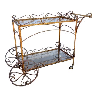 Mid 20th Century Vintage Mid-Century Hollywood Regency Style Gilt Metal Scroll Bar Cart With Smoked Glass Shelves For Sale