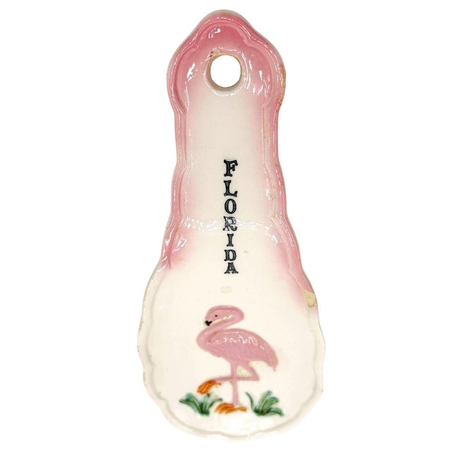 Mid-Century Era pink and green 3D flamingo "Florida" ceramic spoon rest with a curious flamingo in the grass. The spoon...