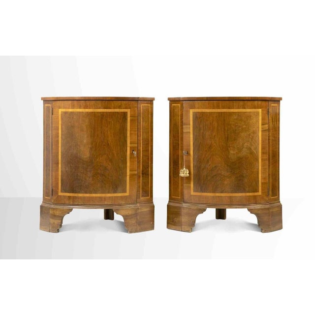 Vintage corner cupboards is a design item realized in the mid-20th Century. Pair of stylish walnut corner cupboards. Pair...