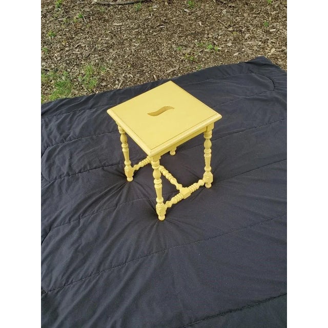 Fresh, painted wood sunshine yellow spot table with finger insert cut out for easy placement in multiple seating areas or...