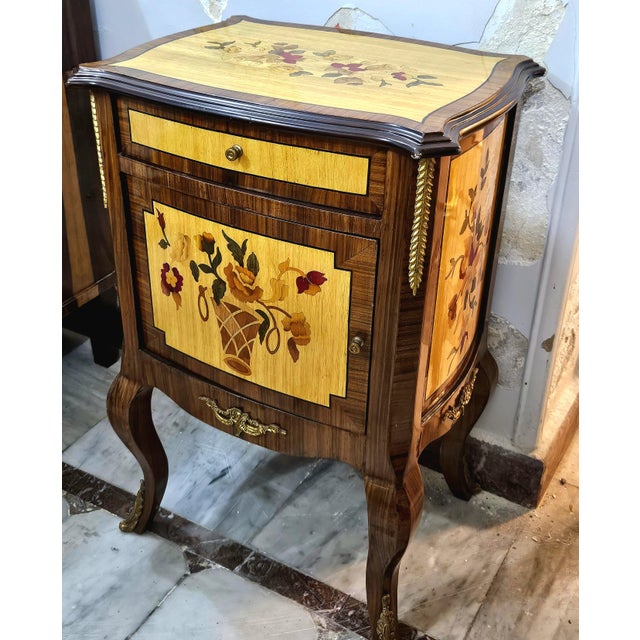 Bring refined European elegance to your interior with this French Louis XV-style marquetry cabinet, featuring a richly...
