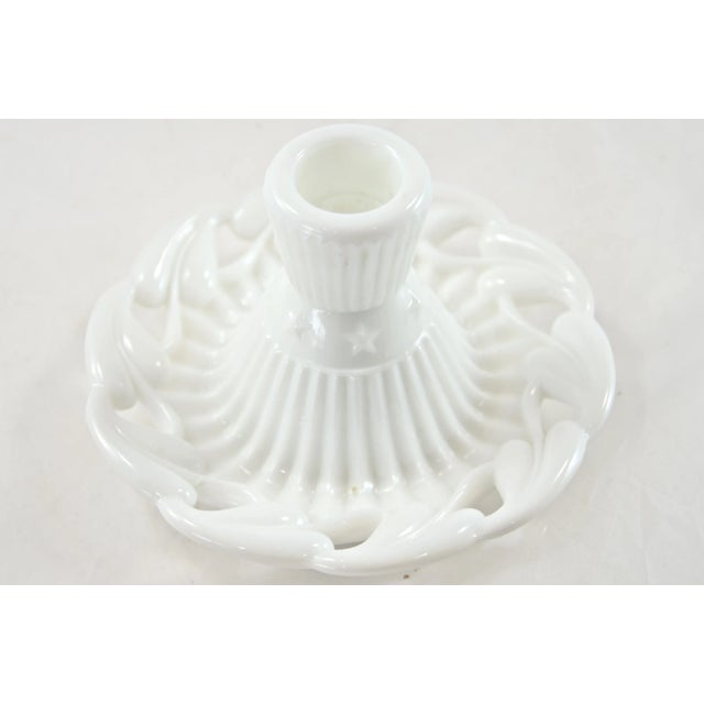 Pair of 1950s white glass candlesticks or candle holders with an open-work design adorned with a wavy leaf rim as well as...