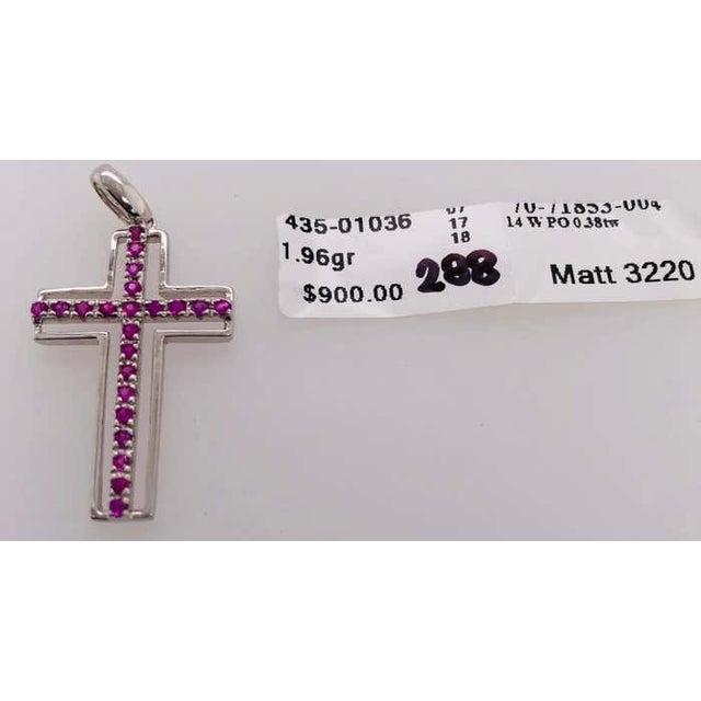 14 Karat White Gold and Pink Topaz Cross Pendant 0.38 Total Weight of Stones 1.96 grams total weight.